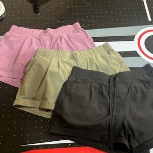 3 pack Zyia athletic shorts the mauve and olive green ones are size s black med